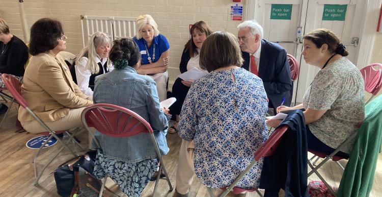 Group of people in discussion at our public REND event.