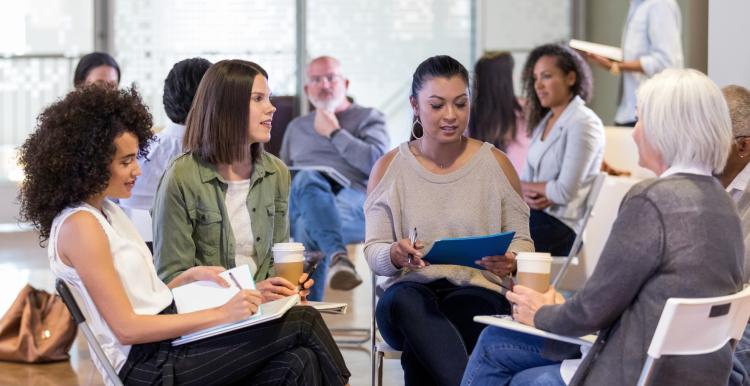 Group of diverse people sitting discussing in a meeting