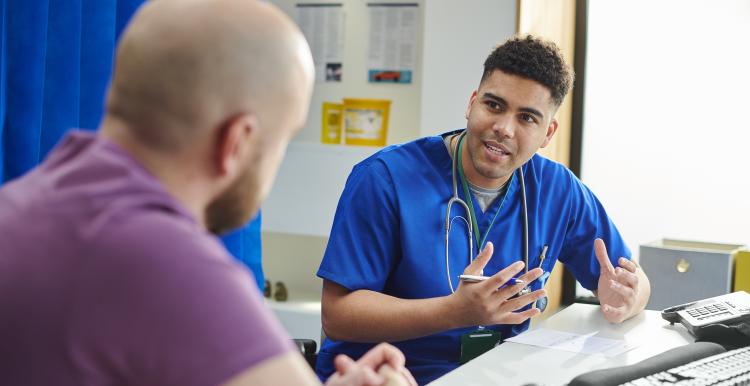 Male doctor talking to a man in a consultation room