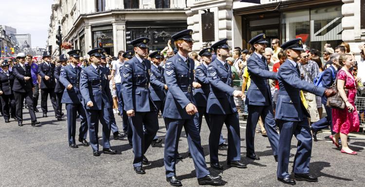Armed Forces personnel marching through a street in the UK