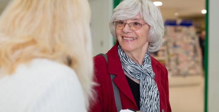 Women talking to a lady with a clipboard