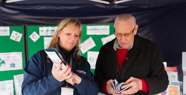 Two volunteers helping each other