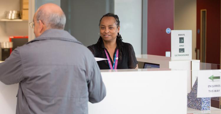 Receptionist talking to a member of the public 