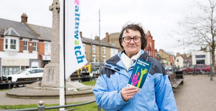 A Healthwatch volunteer holding a leaflet