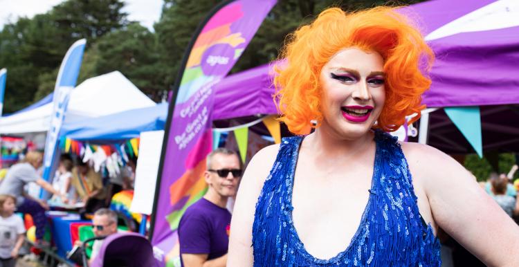 Person celebrating pride with brightly coloured clothes and hair