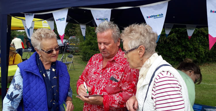 Keith Shephard talking to two members of the public at an event