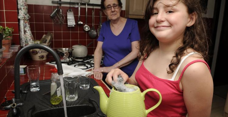 A young female carer helping her mum in the kitchen