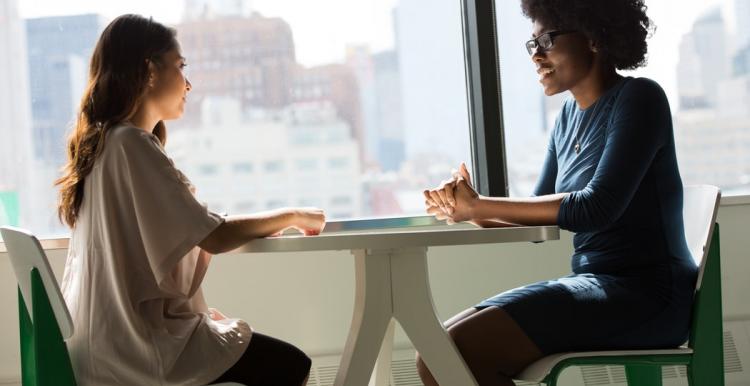 Two people sitting across a table in conversation