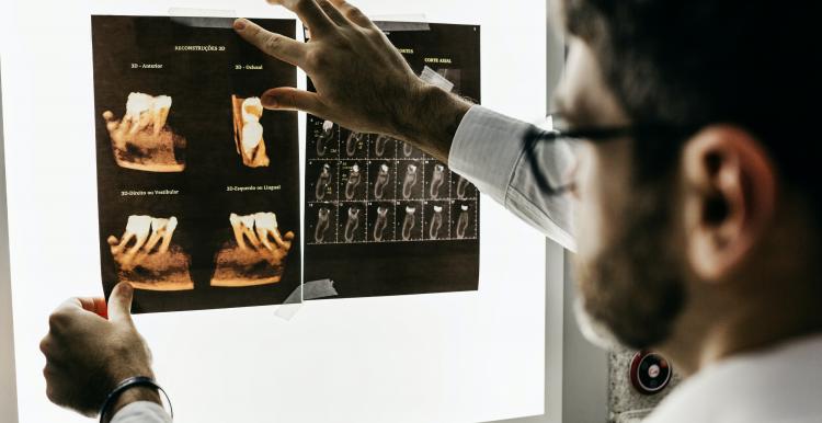 Dentist looking at x-rays of teeth