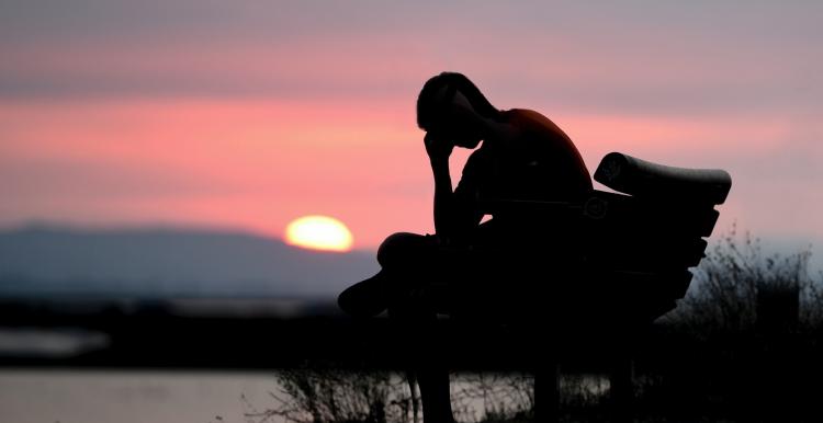 Man thinking at sunset