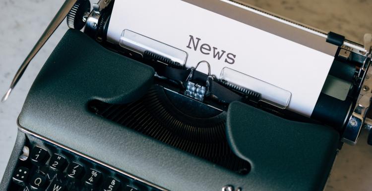 Old typewriter with News typed on white paper