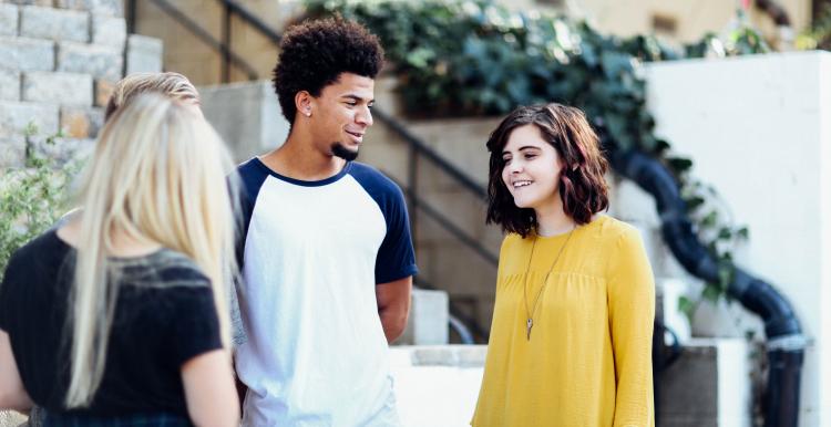 Group of three young people having a conversation