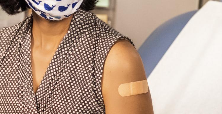 Woman getting covid vaccine in healthcare setting