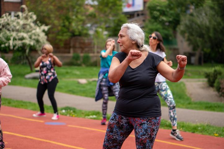 Older group of ladies exercising outdoors