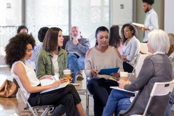 Group of diverse people sitting discussing in a meeting