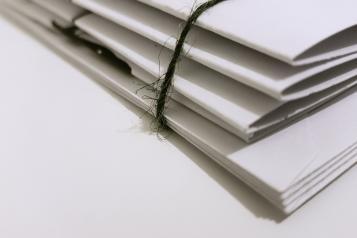 Report papers tied in a bundle sitting on a desk