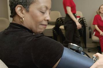 Black woman having blood pressure taken