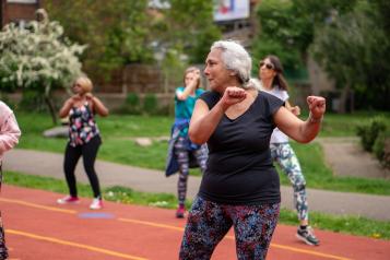 Older group of ladies exercising outdoors