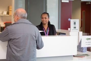 Receptionist talking to a member of the public 