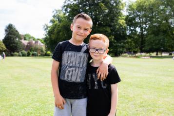 Two young boys with their arms round each other