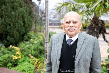 Elderly man standing alone outside