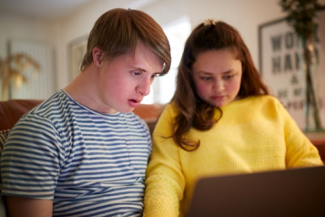 Two people using a computer