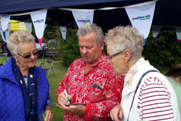 Keith Shephard talking to two members of the public at an event