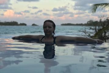 Woman facing camera swimming in a lake