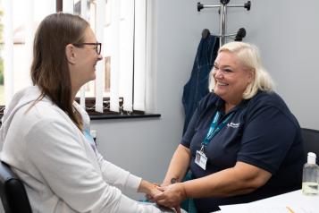 Healthwatch lady talking to a middle-aged woman