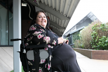 Woman in wheelchair smiling to camera