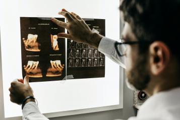 Dentist looking at x-rays of teeth