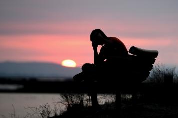 Man thinking at sunset