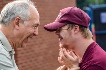 Two men smiling at each other