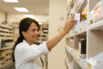 a pharmacist holding medication