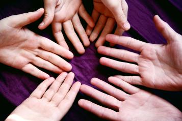 Outstretched open hands on a table