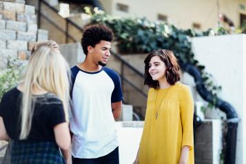 Group of three young people having a conversation