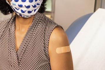 Woman getting covid vaccine in healthcare setting