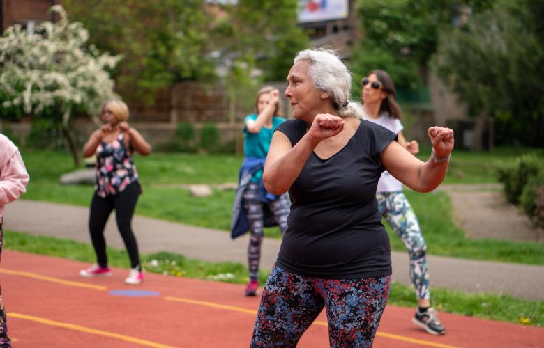 Older group of ladies exercising outdoors