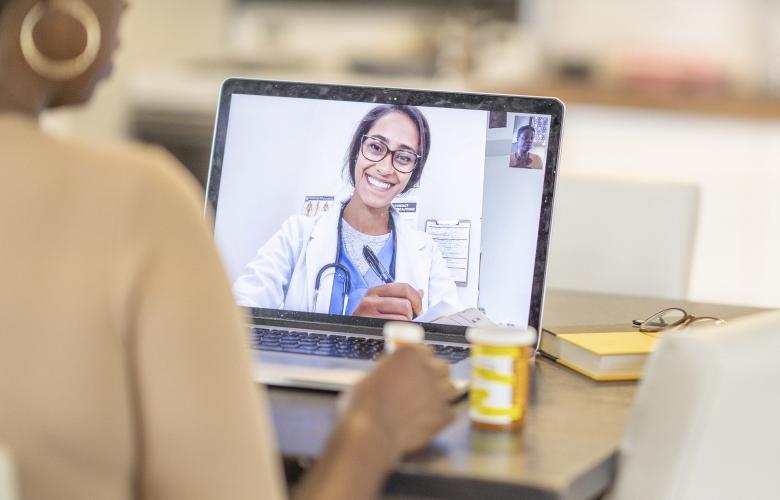 Female doctor having a video consultation with a patient on laptop