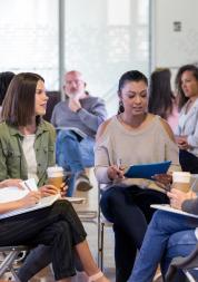 Group of diverse people sitting discussing in a meeting