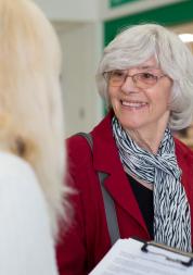 Women talking to a lady with a clipboard