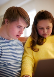 Two people using a computer